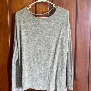 A long sleeve shirt, size medium, no stains or holes, cross back